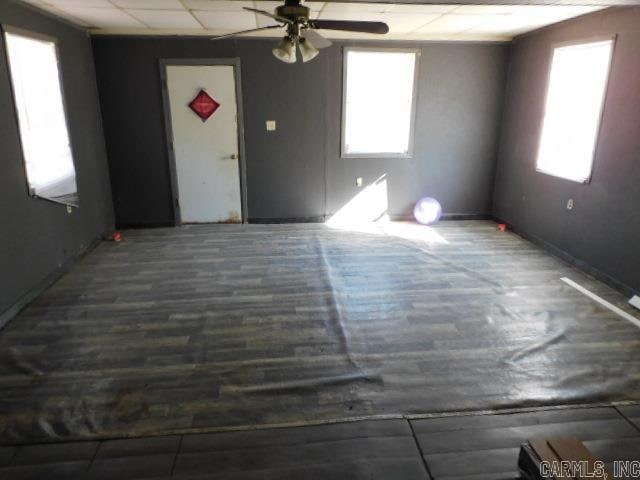 unfurnished room featuring a paneled ceiling and ceiling fan