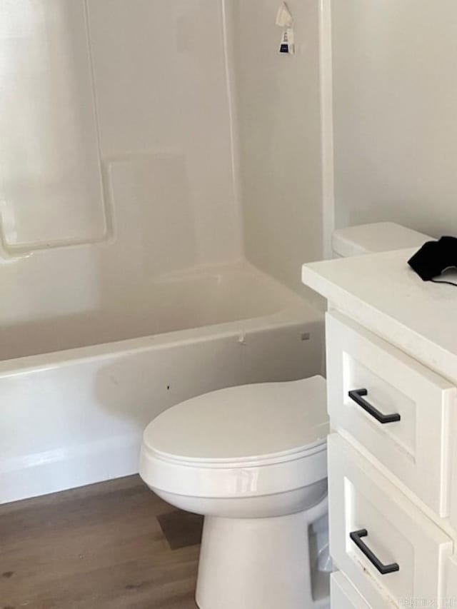 bathroom with vanity, toilet, and hardwood / wood-style floors