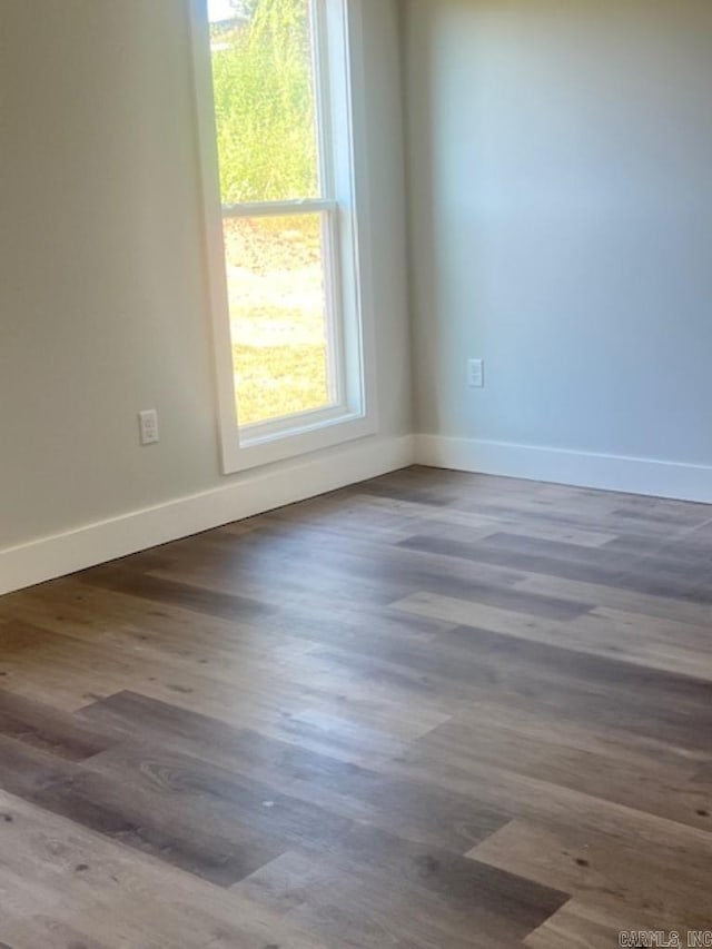 spare room featuring dark hardwood / wood-style flooring