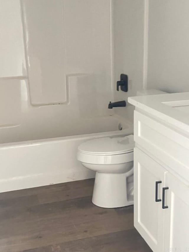 full bathroom featuring vanity, toilet, bathtub / shower combination, and wood-type flooring