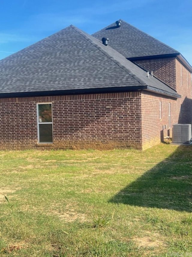 view of home's exterior with a yard and central air condition unit