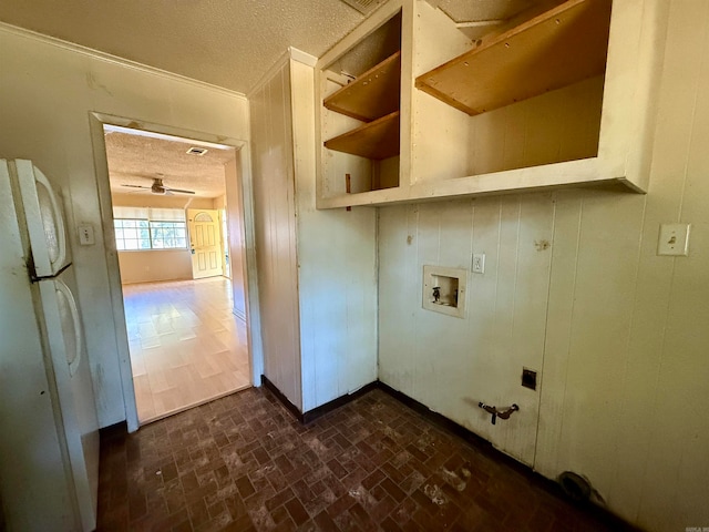 washroom with washer hookup, a textured ceiling, and hookup for a gas dryer