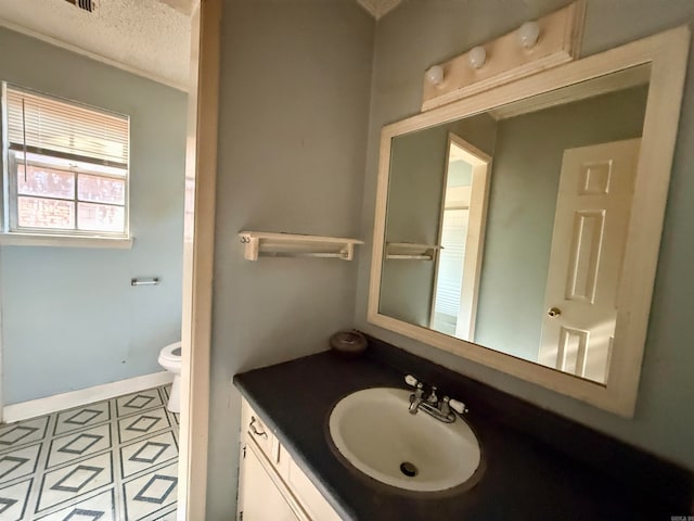 bathroom featuring toilet, a textured ceiling, vanity, and tile patterned flooring