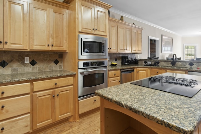 kitchen with stainless steel appliances, a sink, light brown cabinetry, light wood-style floors, and crown molding