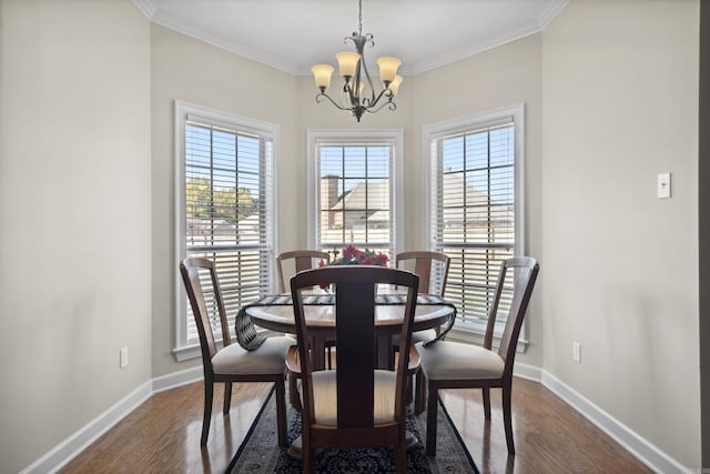 dining room featuring a chandelier, baseboards, dark wood-style flooring, and crown molding