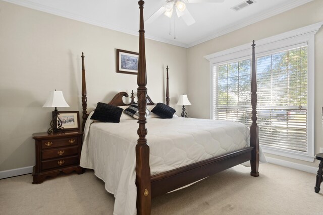 bedroom featuring light colored carpet, crown molding, baseboards, and ceiling fan