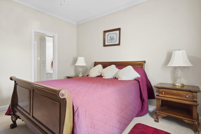carpeted bedroom featuring crown molding and ensuite bath