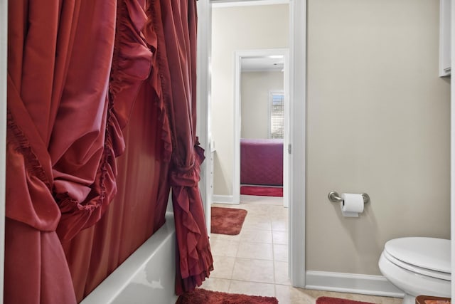bathroom with baseboards, toilet, tile patterned floors, and shower / bath combination with curtain