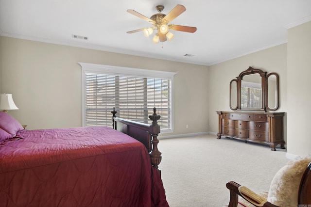 carpeted bedroom featuring ornamental molding, baseboards, and a ceiling fan