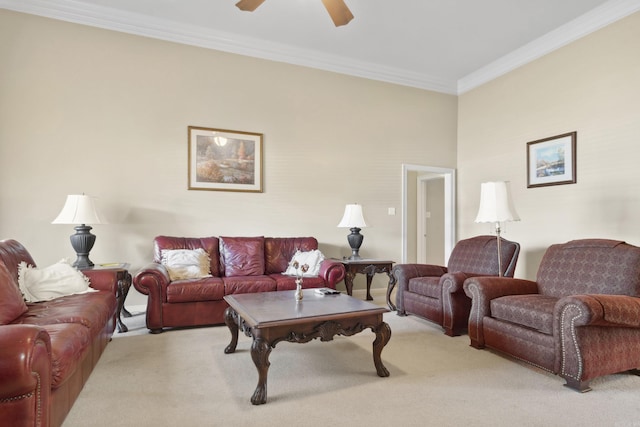 living room featuring light carpet, ornamental molding, and a ceiling fan