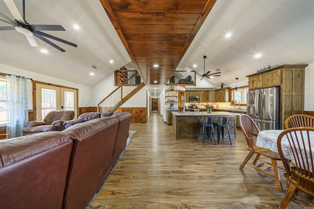 living room featuring lofted ceiling, hardwood / wood-style flooring, sink, and ceiling fan