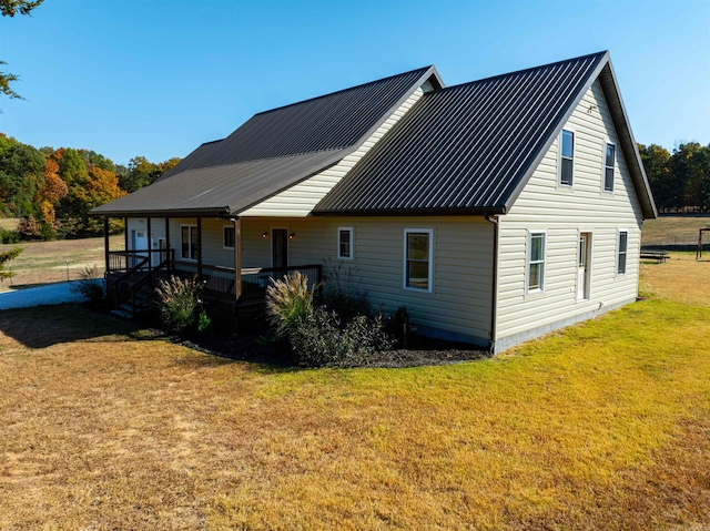 back of house with a lawn