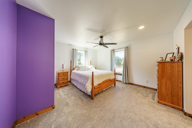 bedroom featuring light carpet and ceiling fan