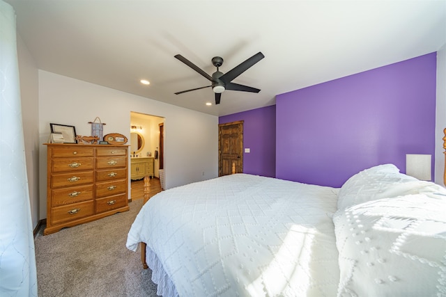 carpeted bedroom featuring ceiling fan and ensuite bath