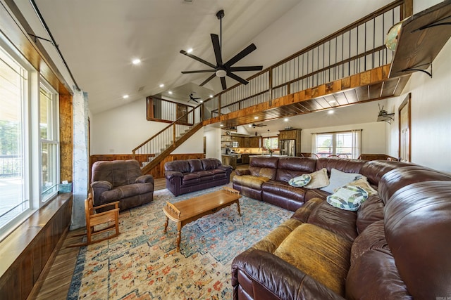 living room with ceiling fan, hardwood / wood-style flooring, and high vaulted ceiling