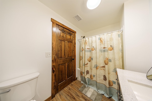 full bathroom featuring vanity, toilet, wood-type flooring, and shower / bath combination with curtain