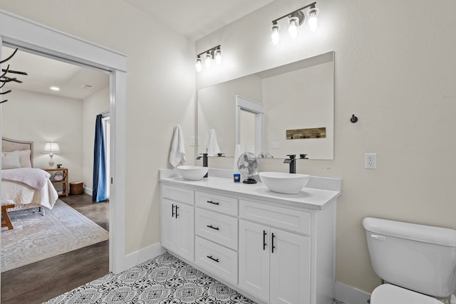 bathroom featuring vanity, toilet, and hardwood / wood-style floors