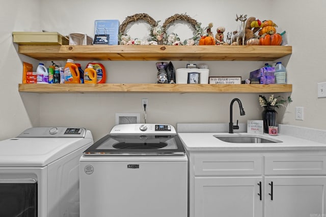 clothes washing area featuring washing machine and dryer and sink