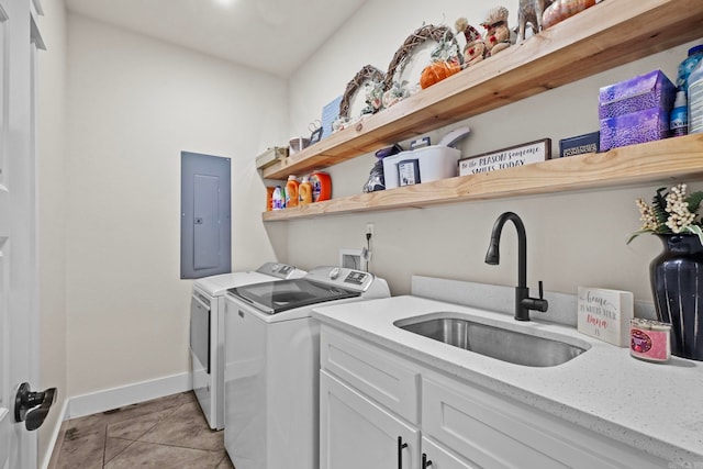 clothes washing area with light tile patterned floors, independent washer and dryer, sink, cabinets, and electric panel