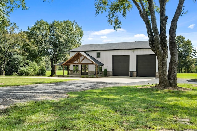 view of front facade with covered porch, a front lawn, and a garage