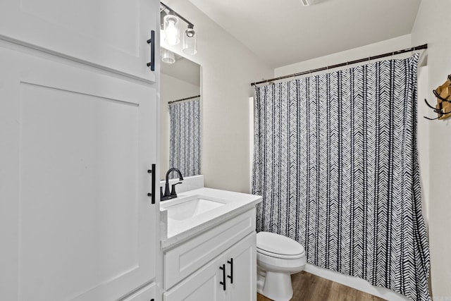 bathroom with vanity, hardwood / wood-style floors, a shower with curtain, and toilet