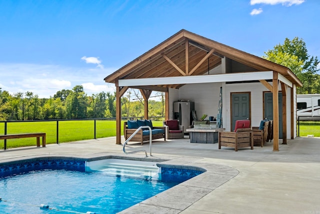 view of pool featuring a patio, water heater, outdoor lounge area, and a lawn