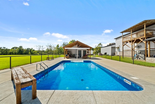 view of swimming pool with a patio area and a lawn