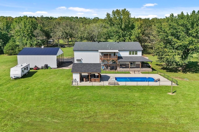 back of property with a patio area and a lawn