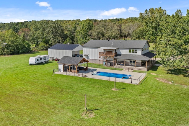 view of pool with a patio and a yard