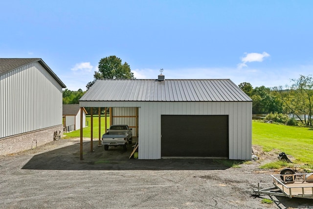 garage with a yard and a carport