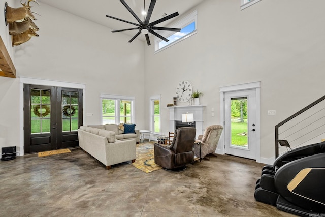 living room featuring a high ceiling, concrete floors, and ceiling fan