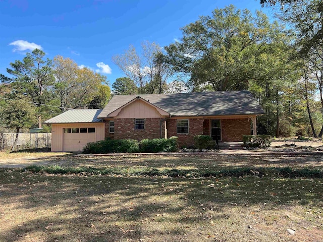 ranch-style home with a front yard and a garage