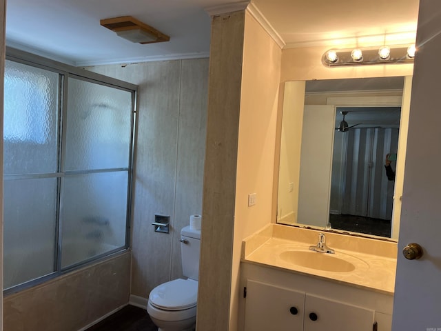 full bathroom featuring vanity, toilet, crown molding, and bath / shower combo with glass door