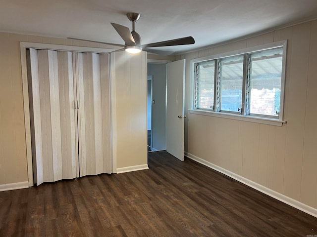 unfurnished bedroom featuring dark wood-type flooring and ceiling fan