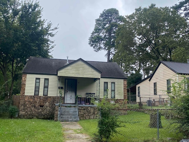 bungalow featuring a porch and a front lawn