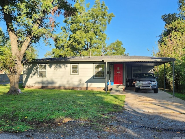 ranch-style house featuring a carport and a front yard