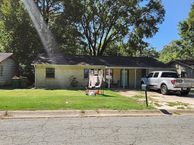 4028 Arapaho Trl, Little Rock, AR 72209 - ranch-style home with brick siding, a front lawn, and driveway