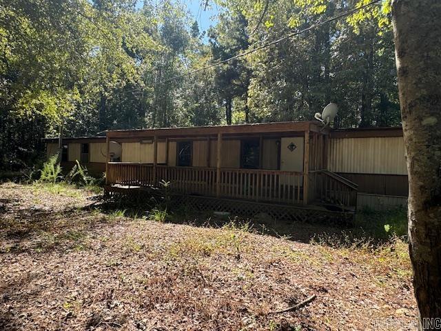 back of property with a wooden deck