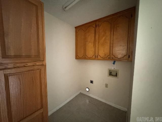 laundry area with electric dryer hookup, washer hookup, and cabinets