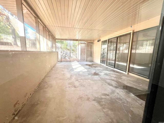 unfurnished sunroom featuring wood ceiling