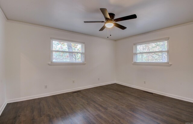 unfurnished room with crown molding, ceiling fan, dark wood-type flooring, and a wealth of natural light