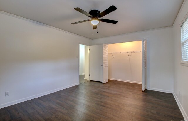 unfurnished bedroom featuring a closet, ceiling fan, crown molding, and dark hardwood / wood-style flooring