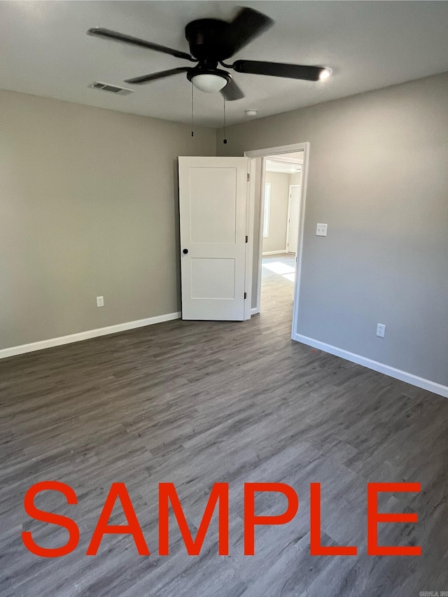 unfurnished room featuring dark wood-type flooring and ceiling fan