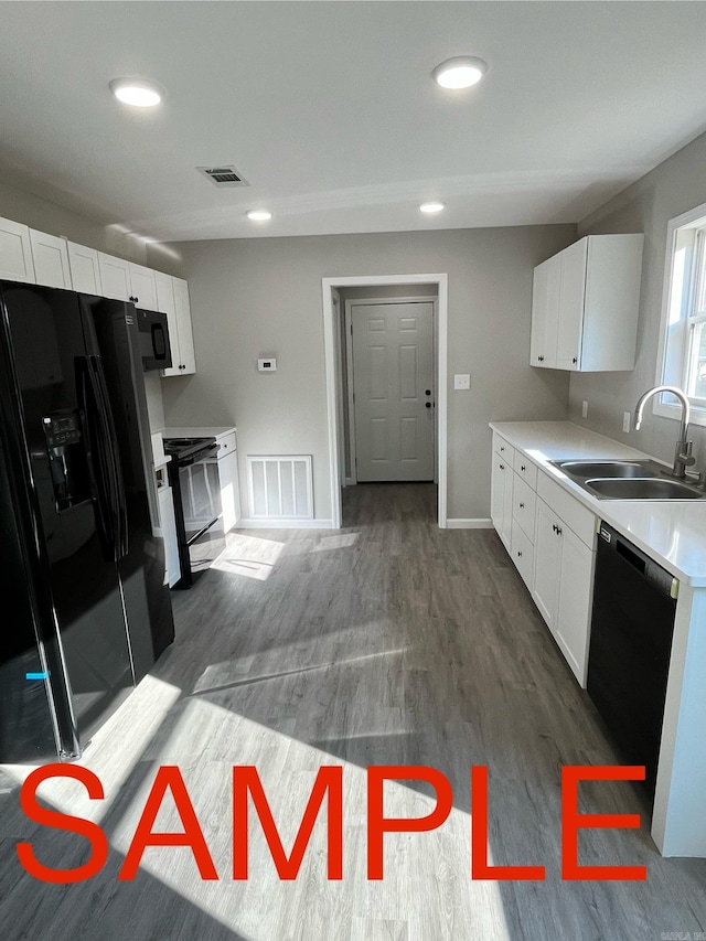 kitchen with white cabinetry, black appliances, sink, and dark hardwood / wood-style flooring