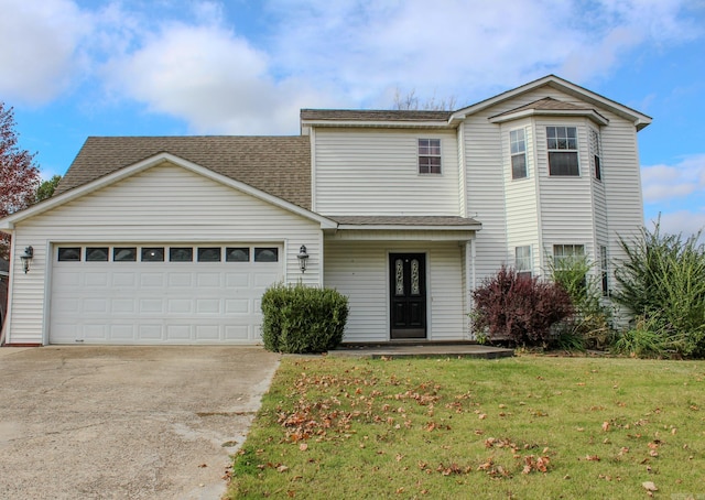 view of property featuring a front yard and a garage