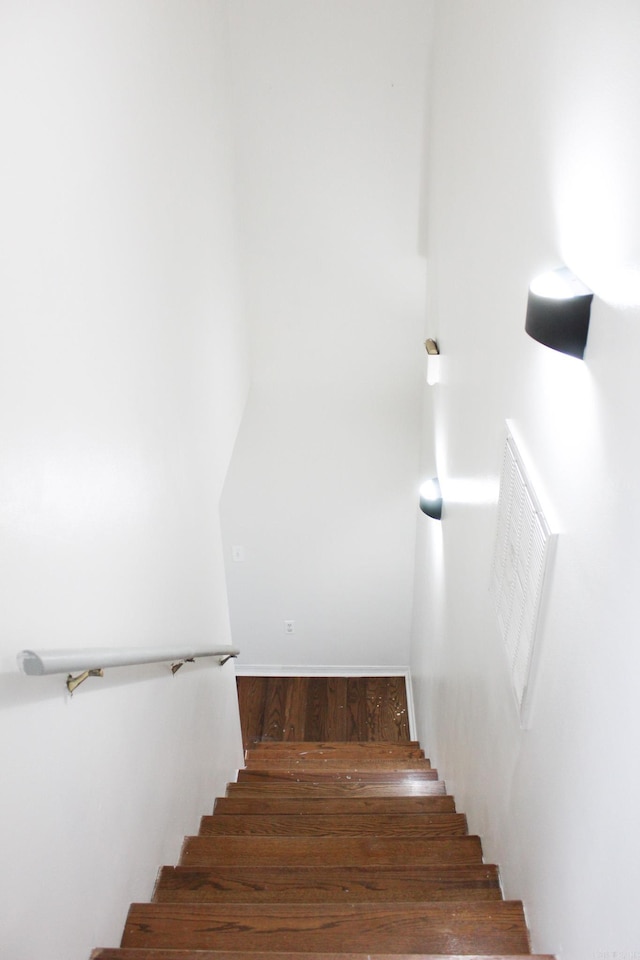 stairs featuring hardwood / wood-style flooring