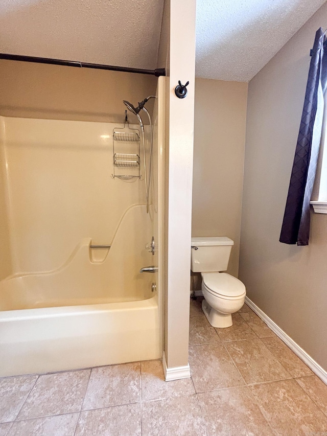 bathroom with toilet, tile patterned floors, a textured ceiling, and shower / tub combination