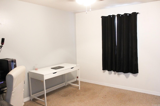 carpeted office space featuring ceiling fan