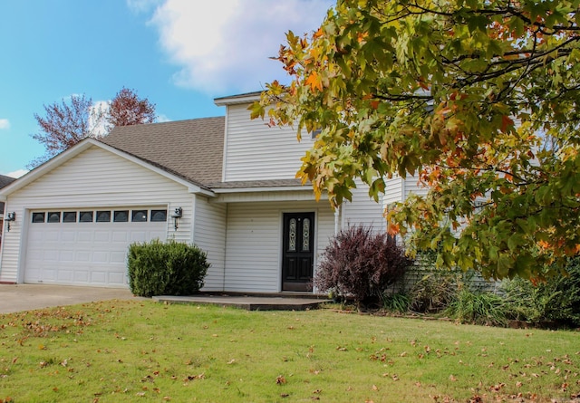 view of front of home featuring a garage and a front lawn