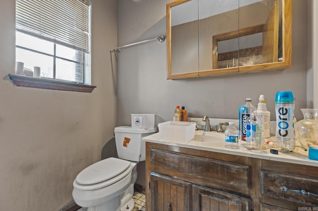 bathroom with vanity, toilet, and tile patterned floors